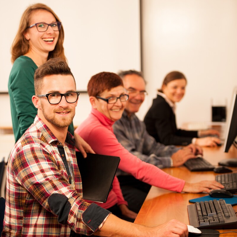 Group of adults learning computer skills
